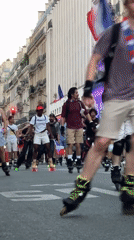 Group skates through Paris streets with flags in tow
