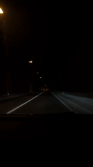 Vehicle travels through lit tunnel in Kavač, Montenegro