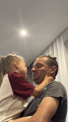 Father, daughter share quiet moment indoors in Chaikovsky