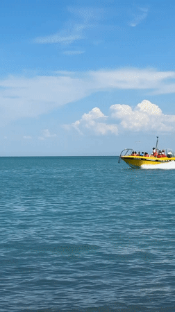 Boats and paddleboards out on the water near Ақши