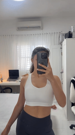 Woman takes morning selfie in bedroom mirror, Holon