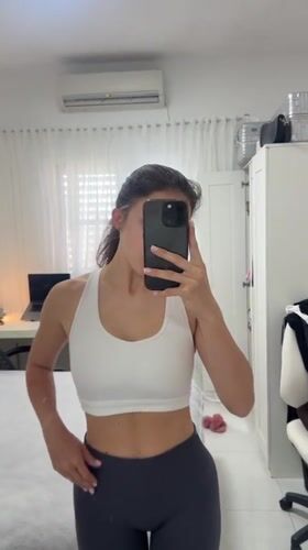 Woman takes morning selfie in bedroom mirror, Holon