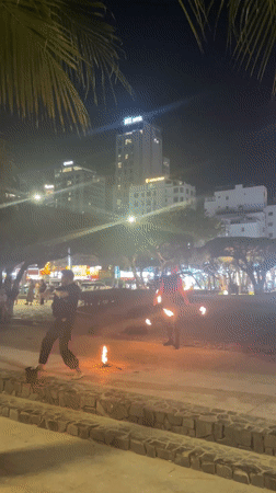 Fire dancer performs for beachgoers in Nha Trang