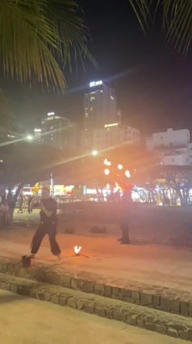 Fire dancer performs for beachgoers in Nha Trang