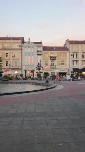 Summer evening around Plovdiv's lit central fountain