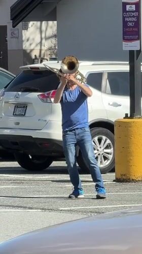 Late-night trombone performance in North Vancouver parking lot