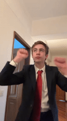 Suited man with American flag pin dances in Vila Real
