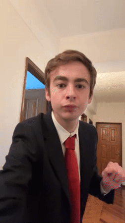 Suited man with American flag pin dances in Vila Real