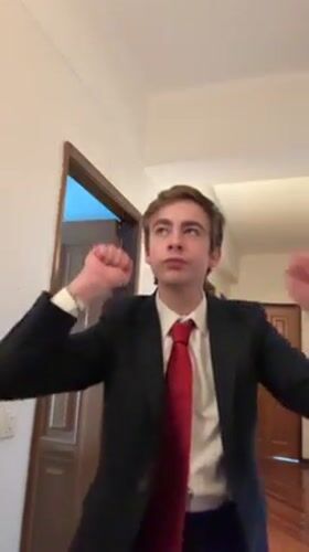 Suited man with American flag pin dances in Vila Real