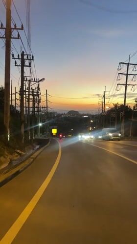 Dusk sky over a Karon road, warm gradient on the horizon
