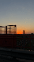 Sunset bridge view and woman in car captured in Reshetnikovo
