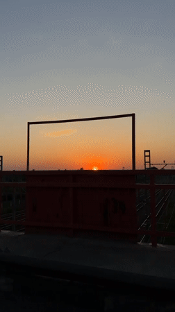 Sunset bridge view and woman in car captured in Reshetnikovo