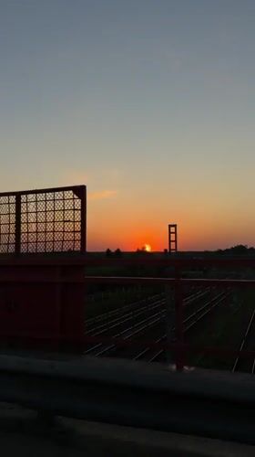 Sunset bridge view and woman in car captured in Reshetnikovo