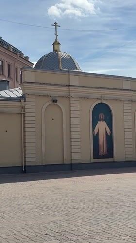 Yellow domed church with Christ fresco on a Saint Petersburg street