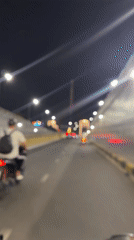 Nighttime motorbike ride captured on Đà Nẵng bridge
