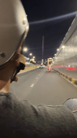 Nighttime motorbike ride captured on Đà Nẵng bridge