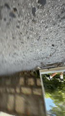 Man sits with phone by mirror in Montenegro coastal town