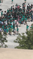 School children in green uniforms gather in Fethiye schoolyard