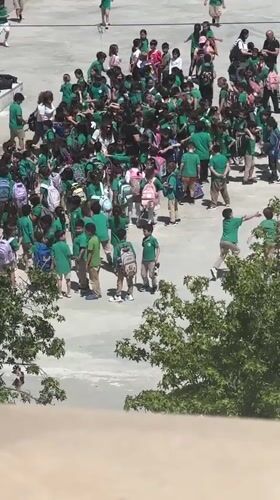 School children in green uniforms gather in Fethiye schoolyard