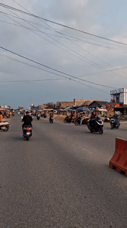 Routine street life documented in Indonesian commercial district