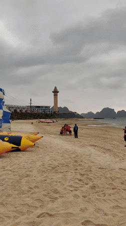 Morning parasailing activity observed at Vietnam beach under cloudy skies