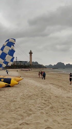 Morning parasailing activity observed at Vietnam beach under cloudy skies