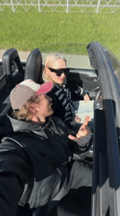 Couple drives convertible through Saint Petersburg streets