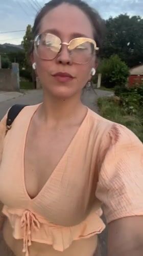 Woman walks residential street during golden hour in Podgorica