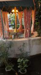 Woman documents visit to floral-decorated venue in Denpasar