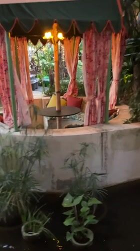 Woman documents visit to floral-decorated venue in Denpasar