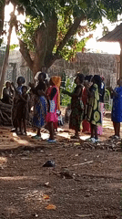 Village gathering in Akwanga with dancing, procession, and communal ceremony.