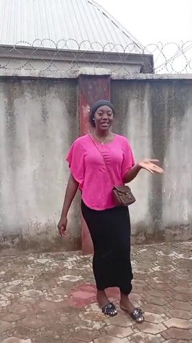 Woman in pink top observed standing in Rido, Nigeria