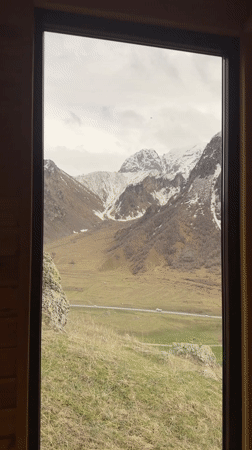 Mountain view captured through window in Pkhelshe, Georgia