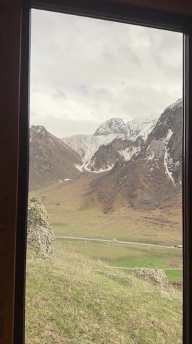 Mountain view captured through window in Pkhelshe, Georgia