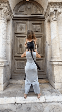 Fashion shoot at a Tel Aviv stone doorway, mid-afternoon.