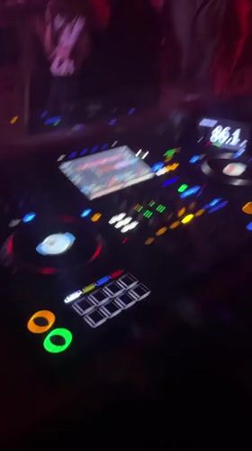 Helmeted DJ performs at Barcelona club venue