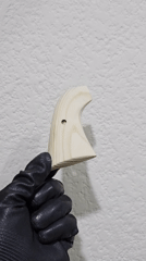 Gloved hands work with drilled wood piece in Puebla
