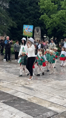School parade with bands, folk dancers in Berkovitsa square
