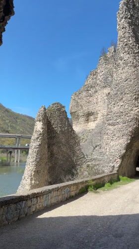 Tourist explores dramatic cliff formations in Asparuhovo, Bulgaria