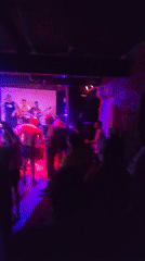 Multi-piece band performs to dancing crowd at Moscow venue