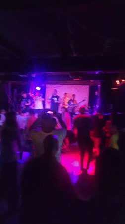 Multi-piece band performs to dancing crowd at Moscow venue