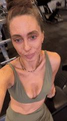 Woman exercises in green athletic wear at Kuta gym