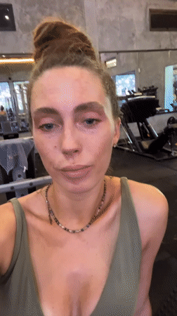 Woman exercises in green athletic wear at Kuta gym