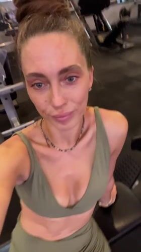 Woman exercises in green athletic wear at Kuta gym