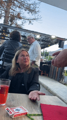 Magician entertains diners with card tricks at French restaurant