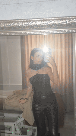 Woman takes mirror selfies in Moscow bedroom