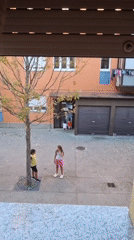 Kids hanging out on a sidewalk in Sant Joan Les Fonts