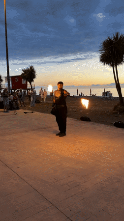 Fire performance on Batumi's beachfront at dusk