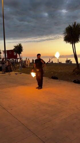 Fire performance on Batumi's beachfront at dusk