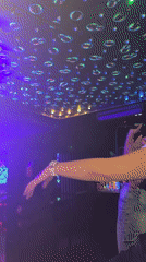 Nightclub scene captured with colorful lighting and dancing patrons
